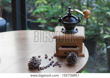 wooden traditional coffee maker with coffee seed on wooden table in coffee shop on natural view at relax coffee time / coffee maker and coffee seed