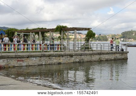 COMBARRO, SPAIN - AUGUST 4, 2016: People in the promenade of Combarro a village of the province of Pontevedra in the Galicia region of Spain.