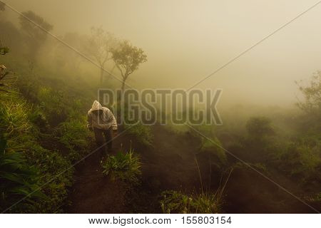 People Travel Hiking Up To Mountain On Misty Weather