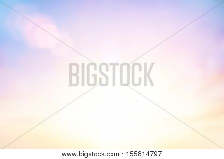Blurred peaceful landscape sunset. Colorful pink blur glowing bokeh and blue sky. Soft focus open view nature. Abstract background Orange and purple gradient. Sunbeam summer rays light sandy