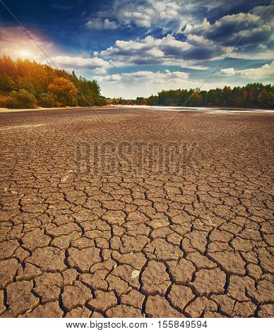 Land with dry and cracked ground. Climate change dry lake