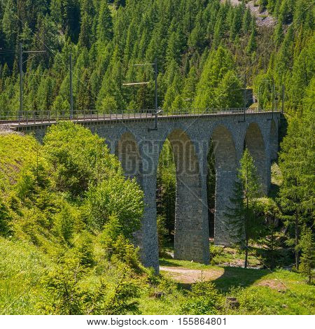 Swiss Alps stone bridge of the Albula Railway. Unesko World Heritage.
