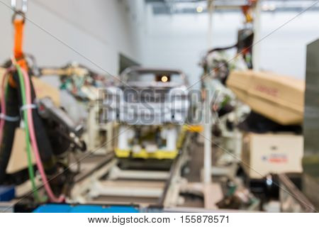 Abstract Blurred Background Interior Of Car Production Factory By Machine And Robot Automaton.