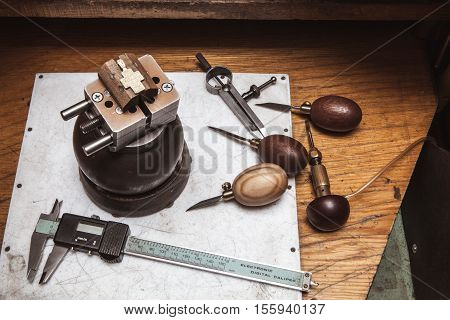 Cross in bullseye vise, gravers and calipers