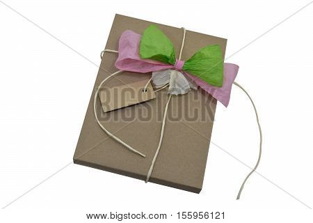 Brown wrapping paper tied with a bow green and pink, Nature paper and notes Isolated in white with path.