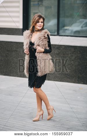 young stylish woman walking on the streets in autumn