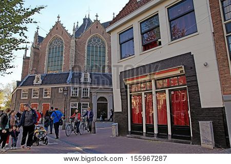 AMSTERDAM, NETHERLANDS - MAY 5, 2016: View of The Old Church (Oude Kerk) in Red-light district in Amsterdam, Netherlands.