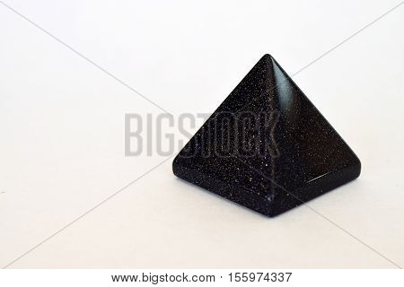 Black Goldstone Crystal Pyramid on White Background