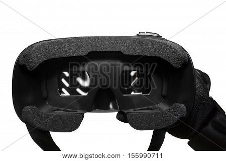 Isolated first person view soldier arm in black battle gloves & tactical jacket holding vr glasses front view.