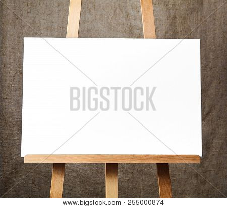 Pure White Synthetic Canvas Stretched On A Wooden Stretcher Standing On A Wooden Easel For Artists. 