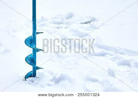 Hand Operated Ice Auger Used In Ice Fishing. Blue Metal Screw. Drill. Hobbies, Winter Fishing On Sno