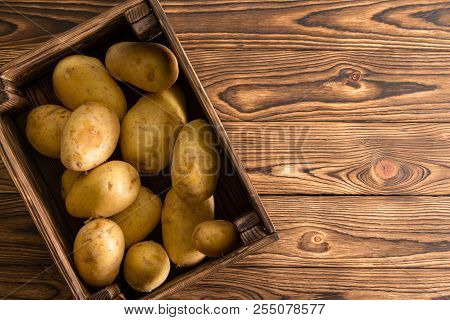 Small Wooden Crate Filled With Fresh Washed Healthy Organic Potatoes On Display On A Table At Famers