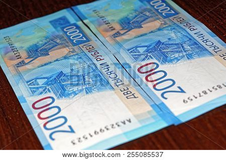 Russian Two Thousandth Notes Close-up Against The Background Of A Dark Wooden Table