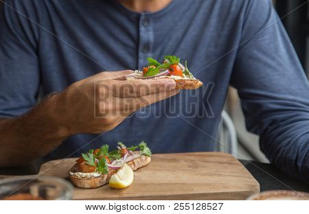 Young Happy Man Eating His Lunch. Handsome Man Enjoying His Organic Food. Healthy Eating Concept