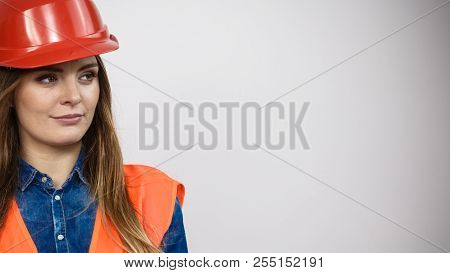 Woman Construction Worker Builder Structural Engineerin In Orange Vest Red Hard Helmet. Safety In In