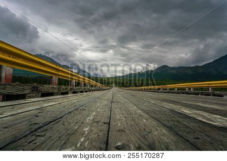 Bridge Over Susitna River Under The Clouds