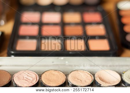 Blurry Professional Visagiste Workspace. Blusher And Cream Concealer Pallet.