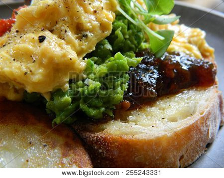 Close Up Of Some Eggs, Sourdough, Chutney, And Mashy Peas