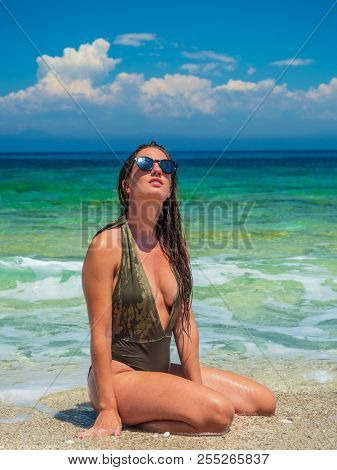 woman sunbathing on the beach summer travel holidays