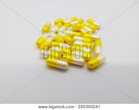 Medical And Healthcare Concept. Many White-yellow Capsules Of Tranexamic Acid 250 Mg. Isolated On Wh