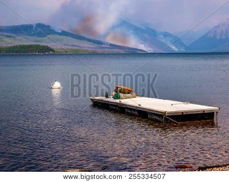 A Tourist Reclines And Takes Time To Observe The Howe Ridge Fire Kicking Up From The Comfort Of A Sw
