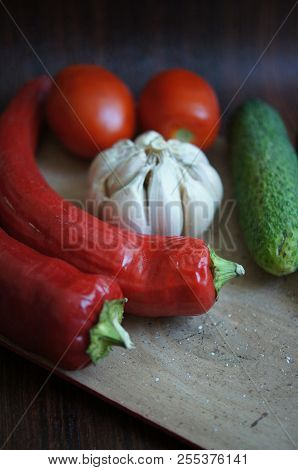 Food - Fresh Vegetables On Wooden Background. Red Chilli Pepper, Red Tomatoes, Garlic, Green Cucumbe