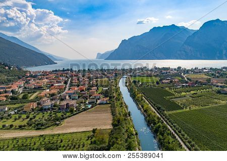 Aerial View On Nago Torbole City And Sarca River.