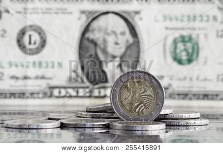 German Euro Coin With Us Dollar Banknote In Background