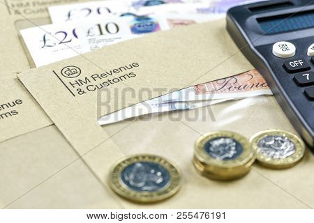 England, Uk - August 16 2018: The Logo Of Her Majestys Revenue And Customs On Envelope, With Money O