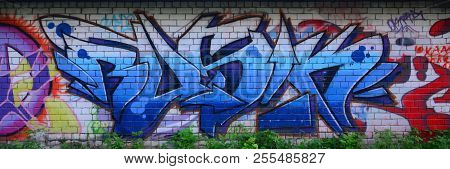 Full And Acomplished Graffiti Artwork. The Old Wall Decorated With Paint Stains In The Style Of Stre