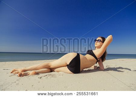 Beautiful Young Woman In Swimsuit At Sand Sea Beach, Toned Image