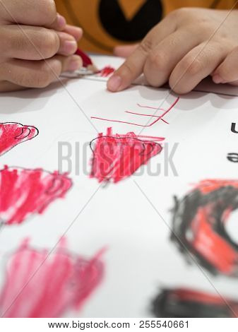 Close Up Of Kids Coloring In Paper