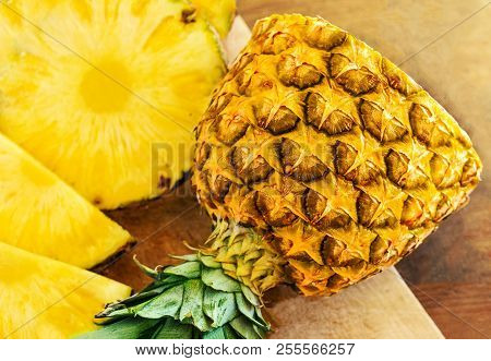 Pineapple On Wood Texture Background. Whole And Sliced Tropical Pineapple On Wooden Cutting Board  W