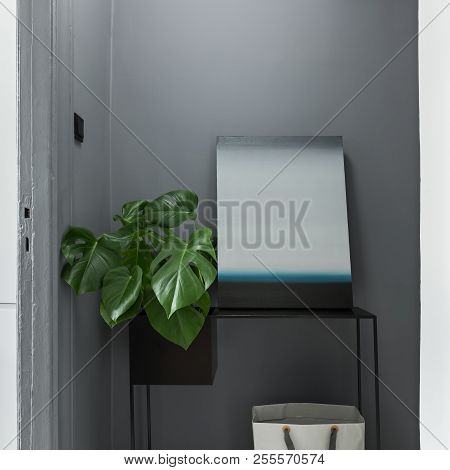 Gray Interior With Black, Metal Table, Modern Painting And Plant
