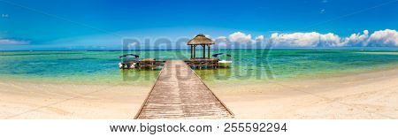 Sandy tropical Wolmar beach at sunny day. Jetty on the foreground. Beautiful landscape panorama. Mauritius