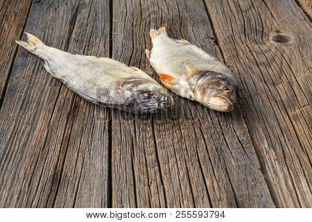 Dried Fish On The Table. Salty Dry River Fish On A Dark Rustic Wooden Background