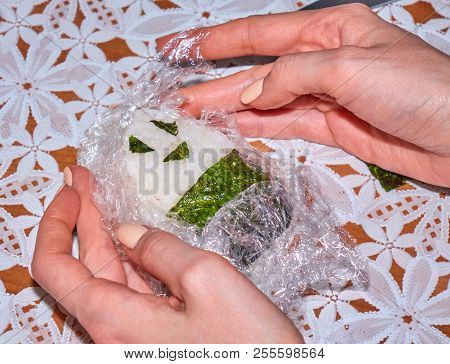 Woman's Hands Cooking Homemade Onigiri With A Smiling Face