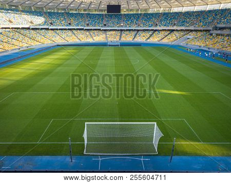 KIEV, UKRAINE - July 19, 2018. National Sports Complex Olimpiysky, panoramic view to a football field, tribune and treadmills of stadium in a summer time before match. Aerial view from drone