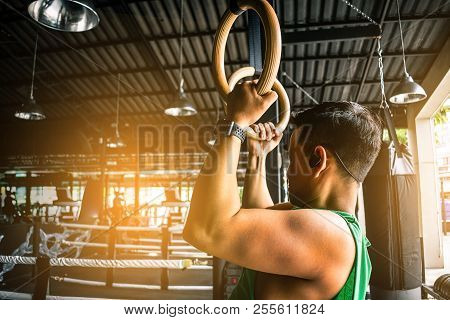 Asian Man Athlete Gymnast Rings Exercise In Gymnastics Exercise Chest 
Workout On Bench Press Cable 