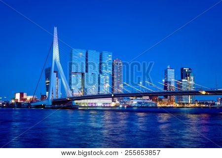 Erasmus Bridge (Erasmusbrug) and Rotterdam skyline illuminated at night. Rotterdam, Netherlands