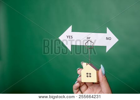 Home Insurance Concept, Little House With Text Yes Or No, Isolated On Green Background.homeless, The