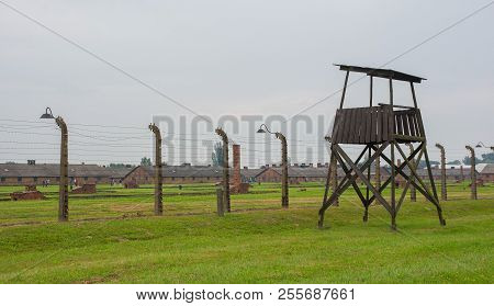 Oswiecim, Poland - July 11th 2018. A Guard Tower And Barbed Wire Fences In The Birkenau Auschwitz Ii