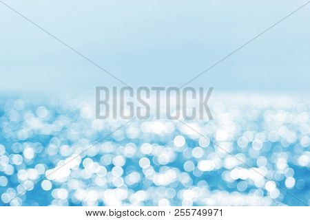 Blur Tropical Beach With Bokeh Sun Light Wave Abstract Background. Copy Space Of Outdoor Summer Vaca