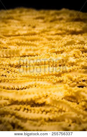 Rows Of Mafalde Pasta With Black Background.