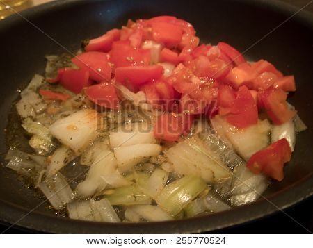Tomatoes And Onion In A Frying Pan