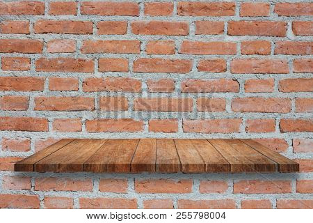 Top Of Broen Wooden Shelf On Old Brick Wall. For Product Display