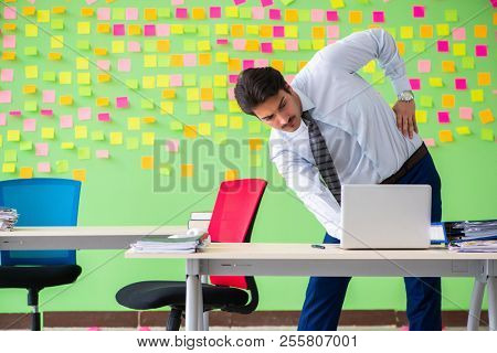 Man in the office with many conflicting priorities doing exercis
