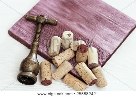 Wine Corks With Corkscrew On Wooden Surface. Background With Cope Space. Selective Focus.