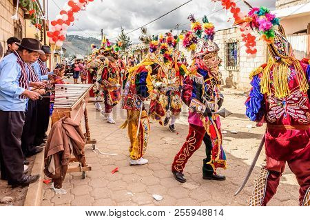 Parramos, Guatemala - December 29, 2016: Marimba Musicians & Traditional Folk Dancers In Masks & Cos