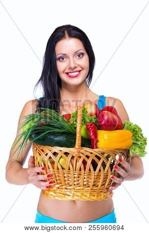 Portrait of slim fitness cherrful girl in studio with set of fruit and vegetables over white background. Healthy eating, diet, fitness, weight lose, fitness diet, workout programs for women concept.